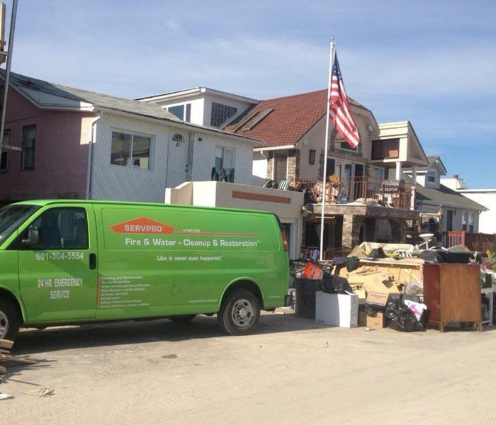 SERVPRO of Natchez truck in front of a home damaged by hurricane