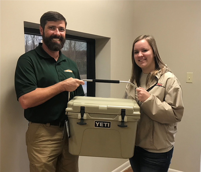 SERVPRO owner posing with Brook Johnson and YETI cooler