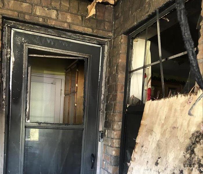 Fire damage to the front door and window of a home